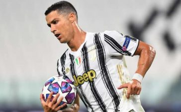 Cristiano Ronaldo pega na bola depois de cobrar um penalti no jogo entre Juventus e Lyon