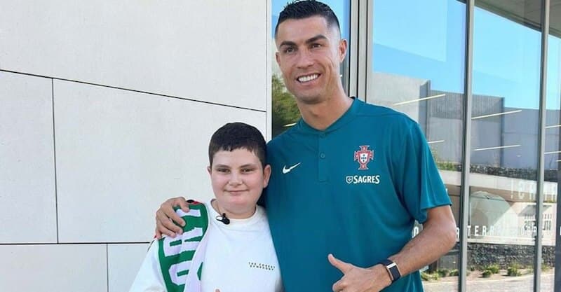 Cristiano Ronaldo ao lado de Francisco, menino que perdeu os pais numa explosão.